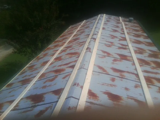 Rusted metal roof panels with new wood purlins before replacement — Storm Damage Roof Repair in Chester by Roofing Brothers